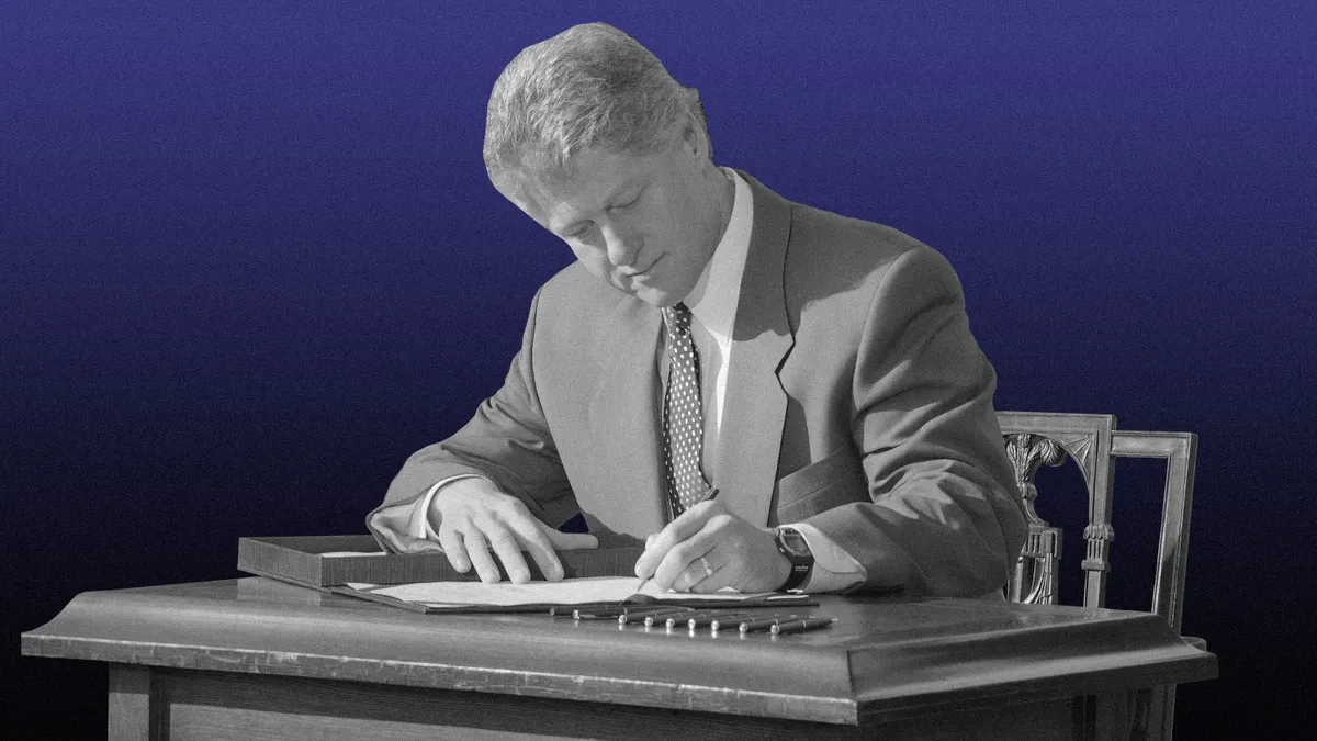A cut out image of a person singing a document at a desk.