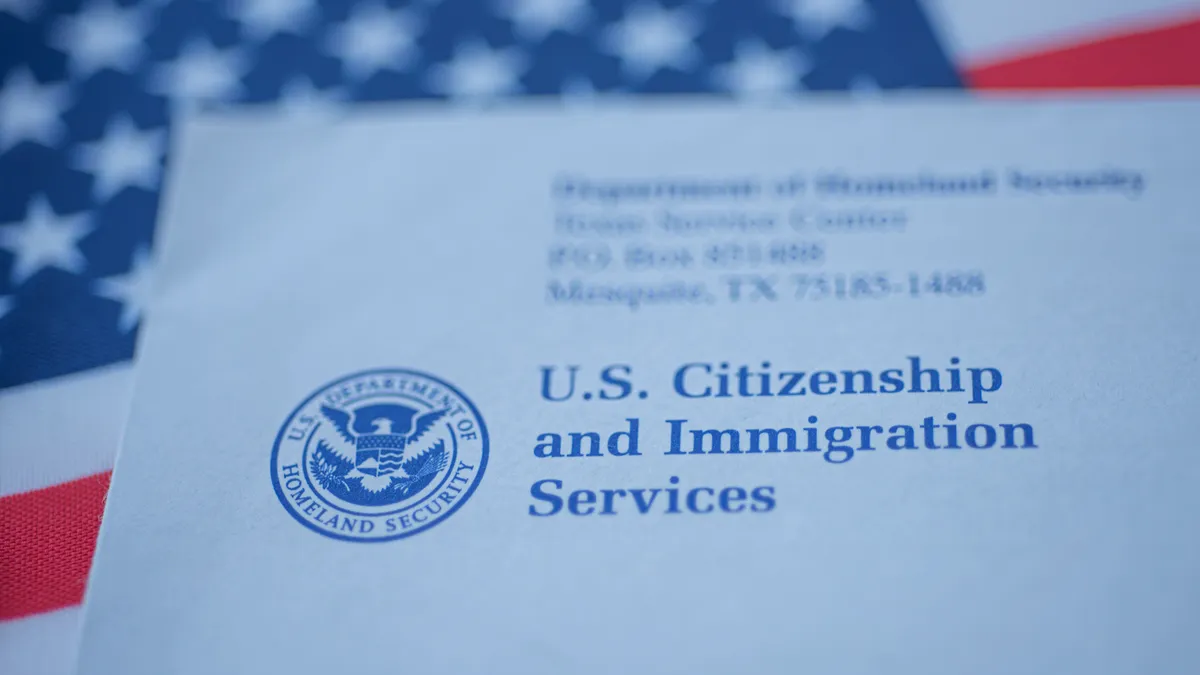 Letter (Envelope) from USCIS on flag of USA background. Close up view.