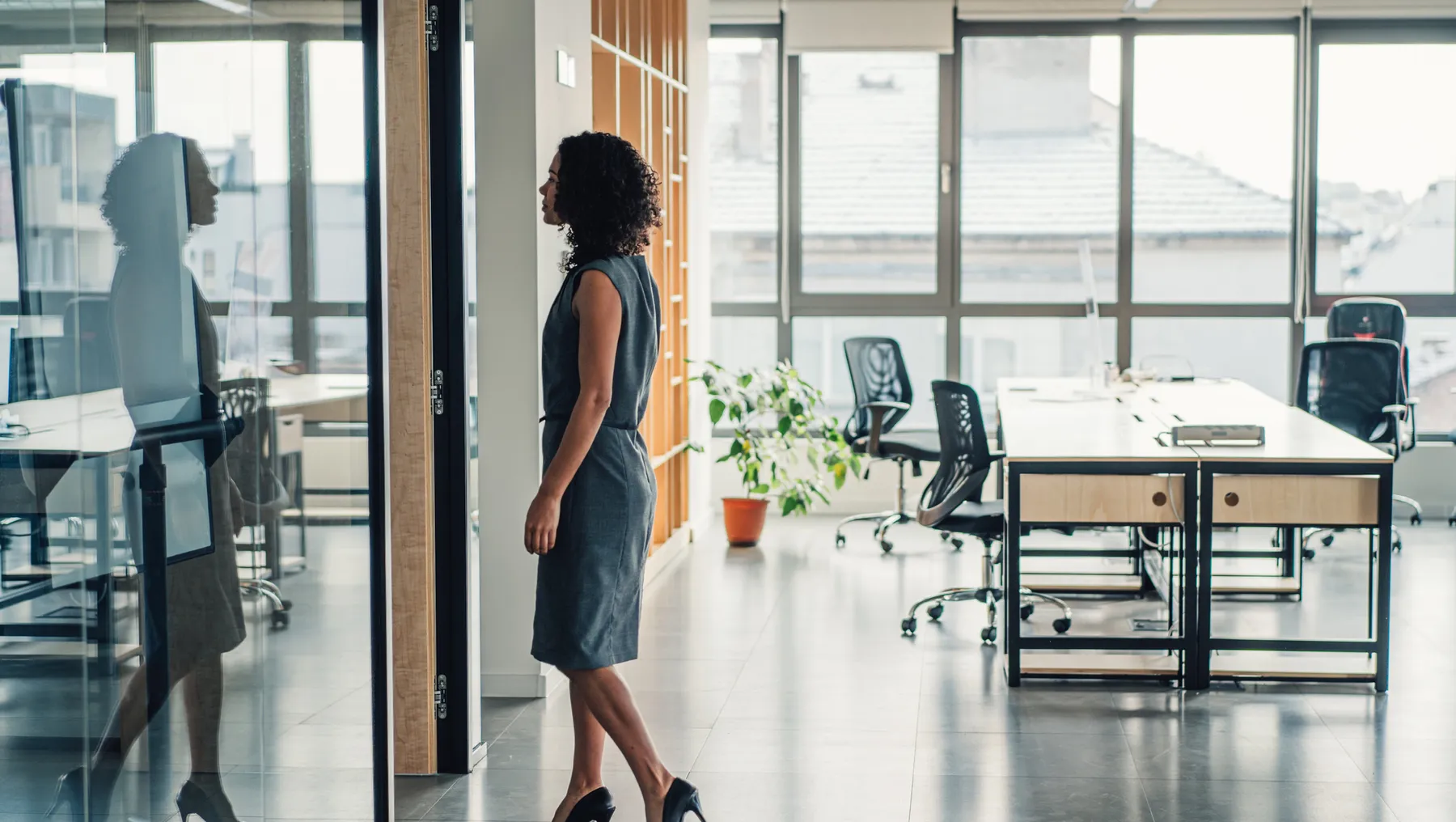 Businesswoman walking in modern office.