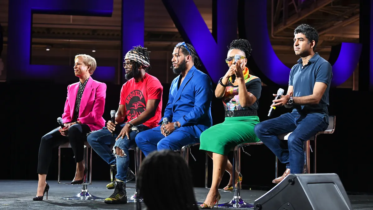 Five people (Tonya Lewis Lee, Omari Maynard, Bruce McIntyre III, Shawnee Benton Gibson and Dr. Neel Shah) sit on stage with microphones.