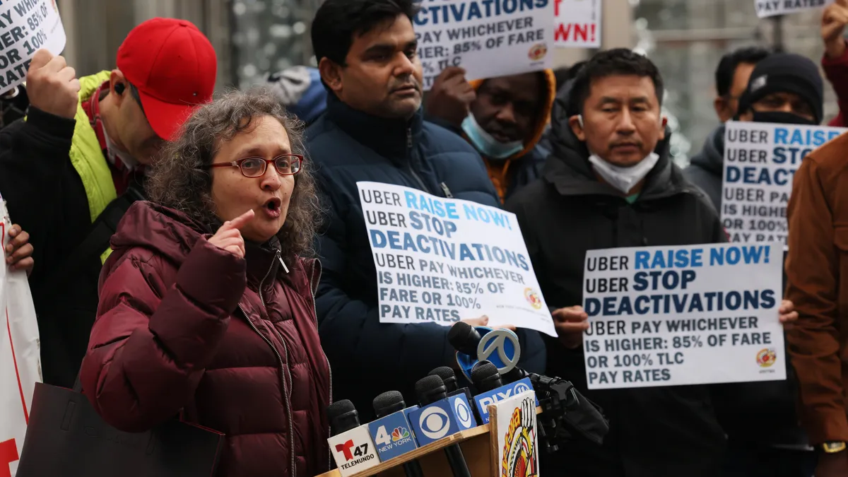 Executive director of New York Taxi Workers Alliance Bhairavi Desai speaks as Uber drivers participate in a rally outside of the Uber Headquarters on January 05, 2023 in New York City.