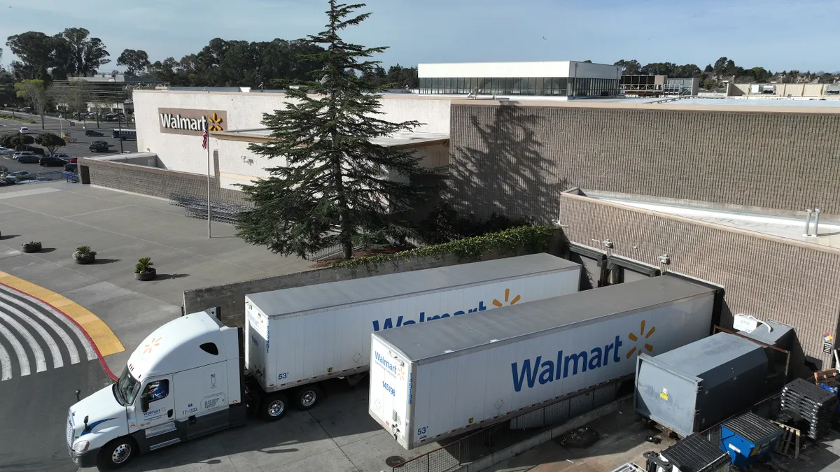 In an aerial view, trucks sit parked in front of a Walmart store on February 21, 2023 in Richmond, California.
