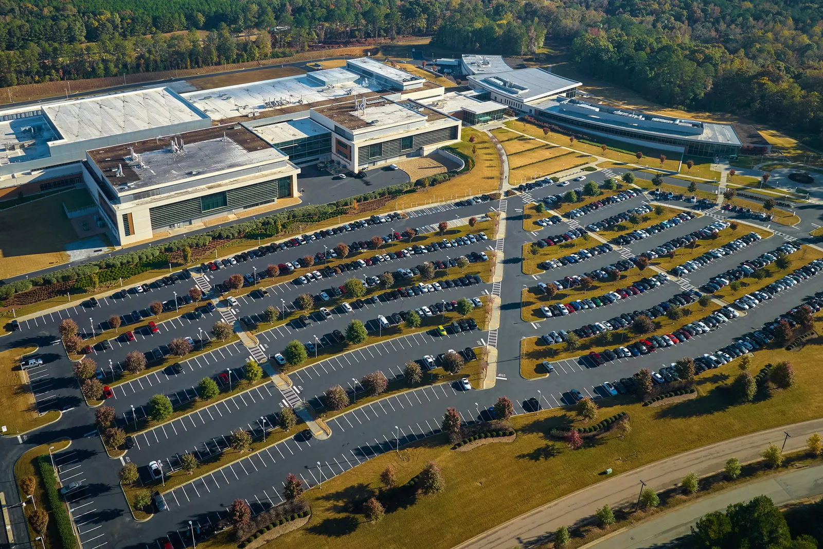 An aerial view of a large commercial complex with rows of parking.