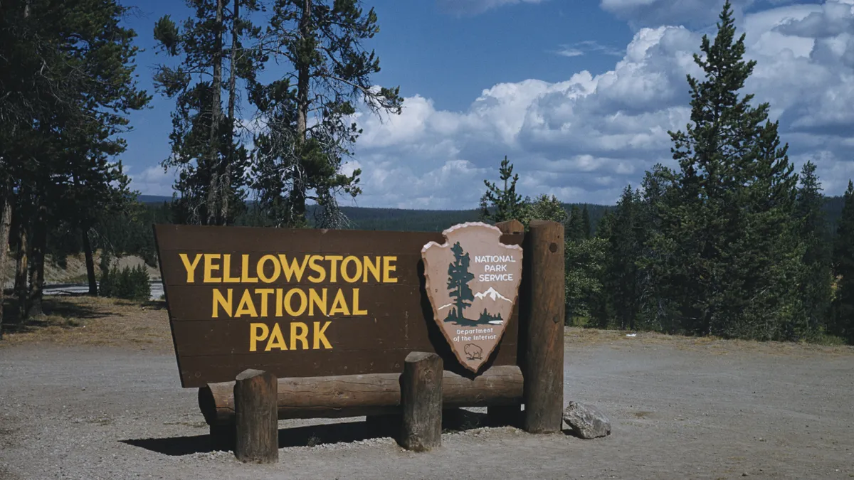 A sign at the south entrance to Yellowstone National Park, Wyoming, courtesy of the National Park Service, Department of the Interior, USA, circa 1965.