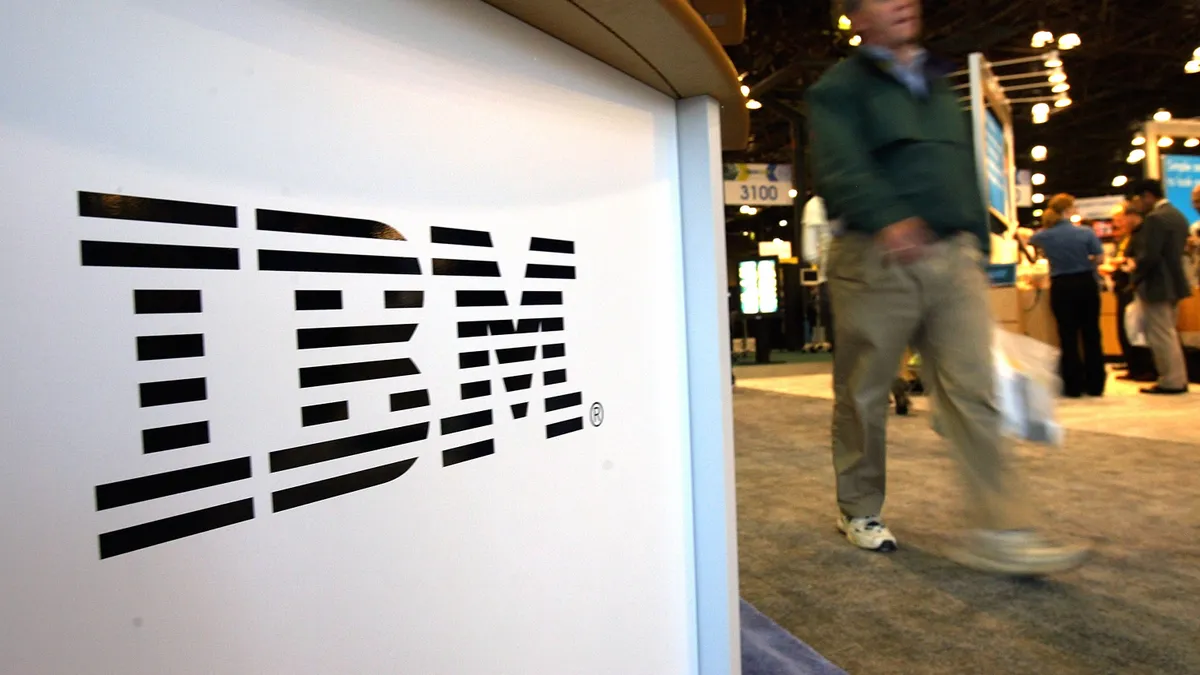 A person walks past an IBM sign October 5, 2004 at the TECHXNY show in New York City.
