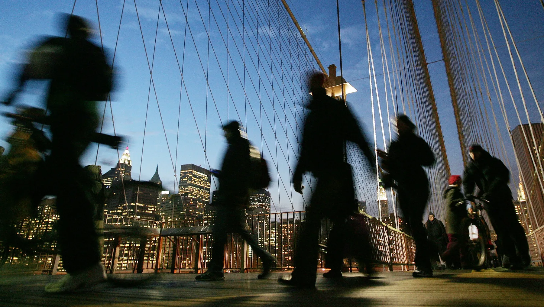 Commuters walk Brooklyn Bridge