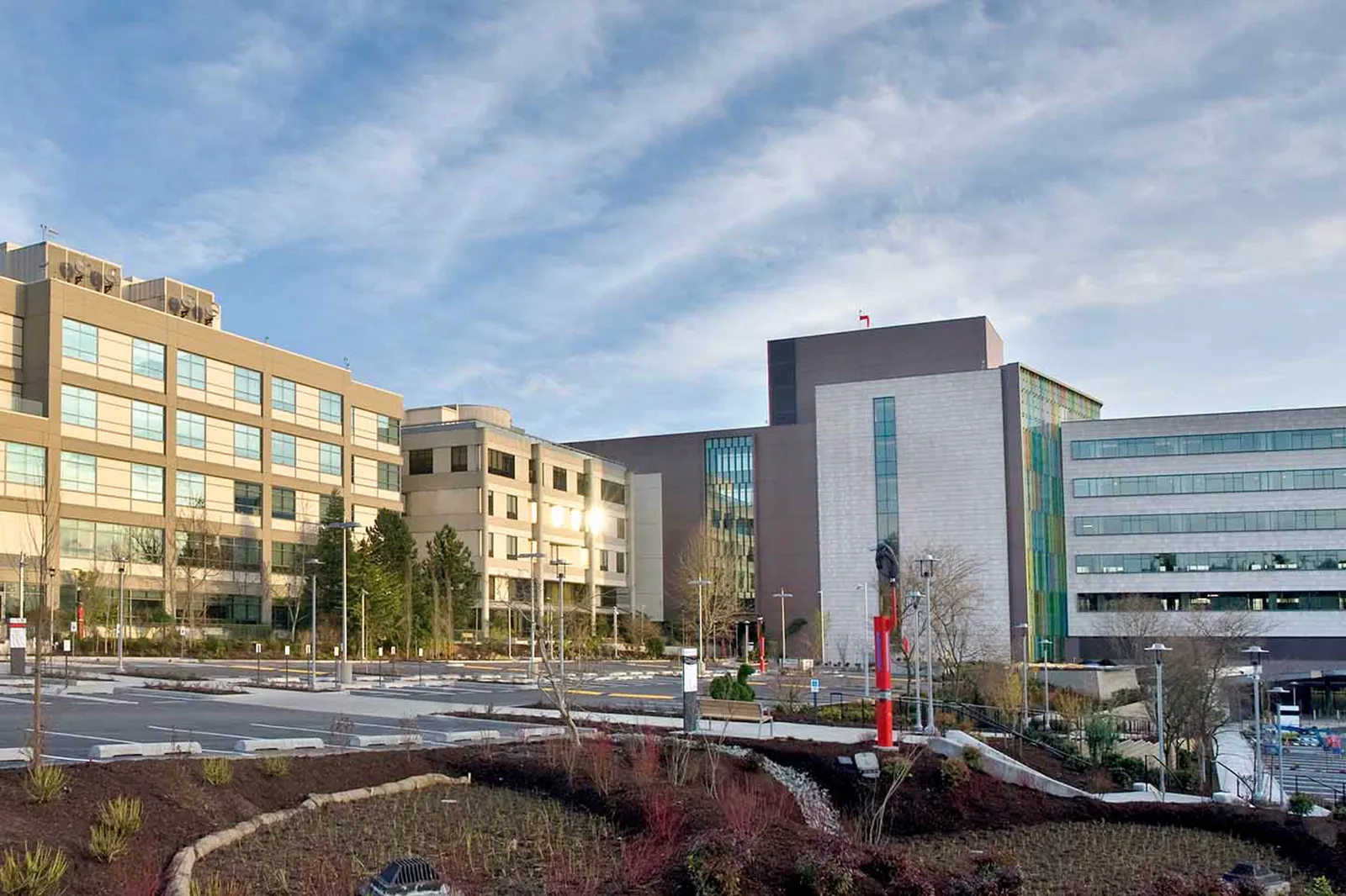 A large building complex with an empty parking lot.