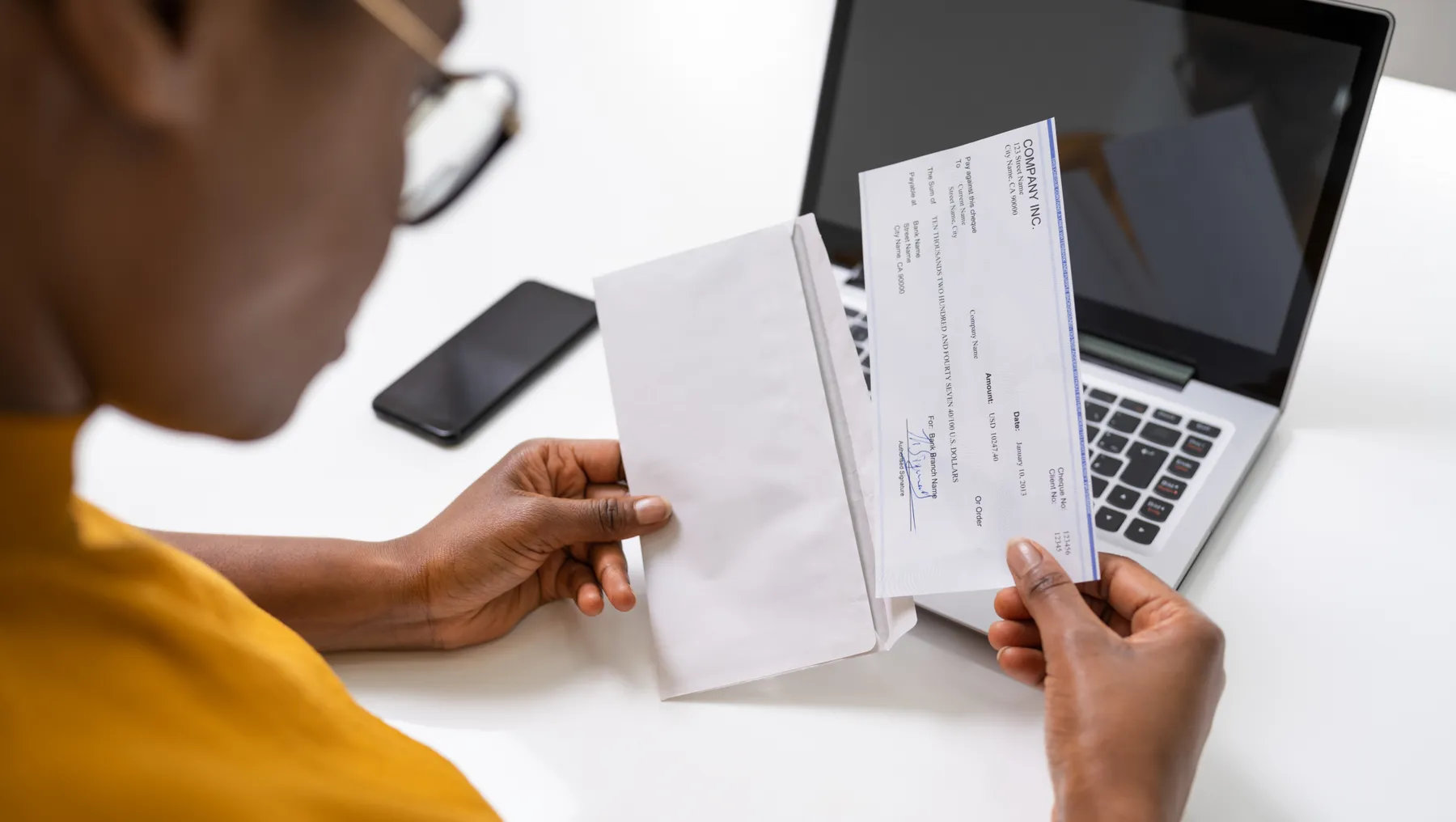 American African Holding Paycheck Or Payroll Check