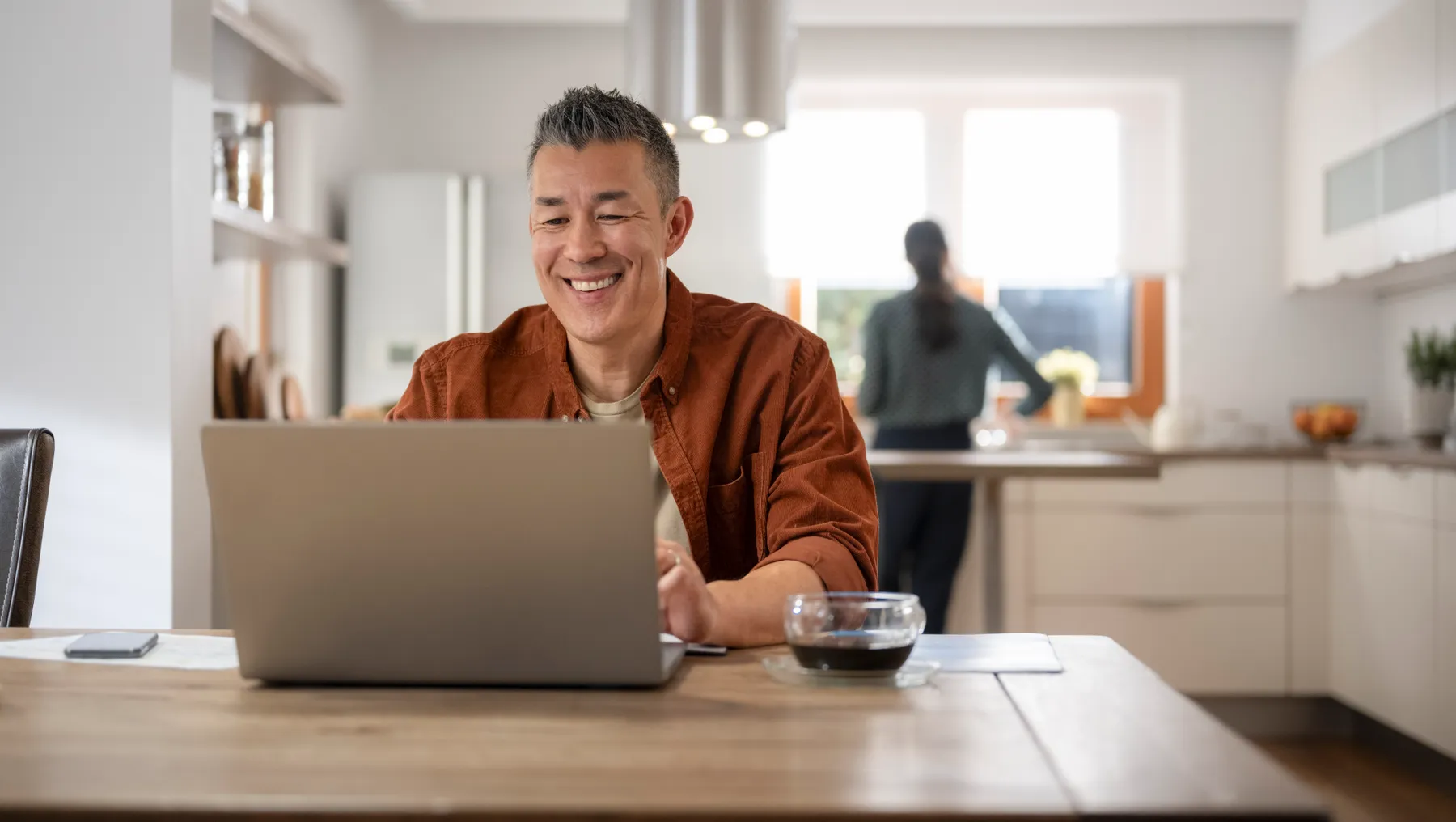 Person sitting at table with laptop open